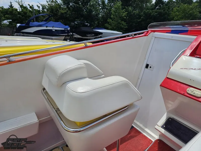 Slide: The Image of Interior of a 2004 Sonic USA 45SS boat with white seating and red accents. - 47