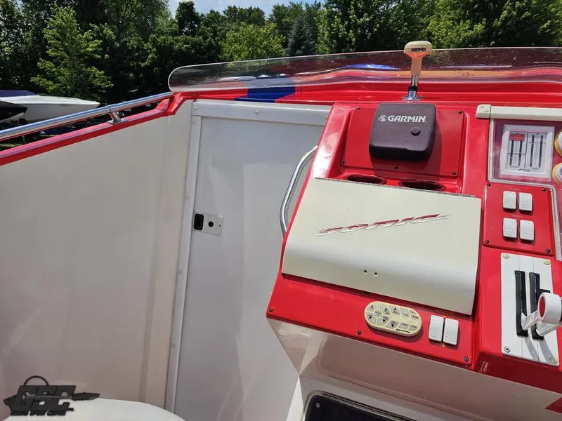 Slide: The Image of Red and white dashboard of a 2004 Sonic USA 45SS boat with Garmin device. - 49