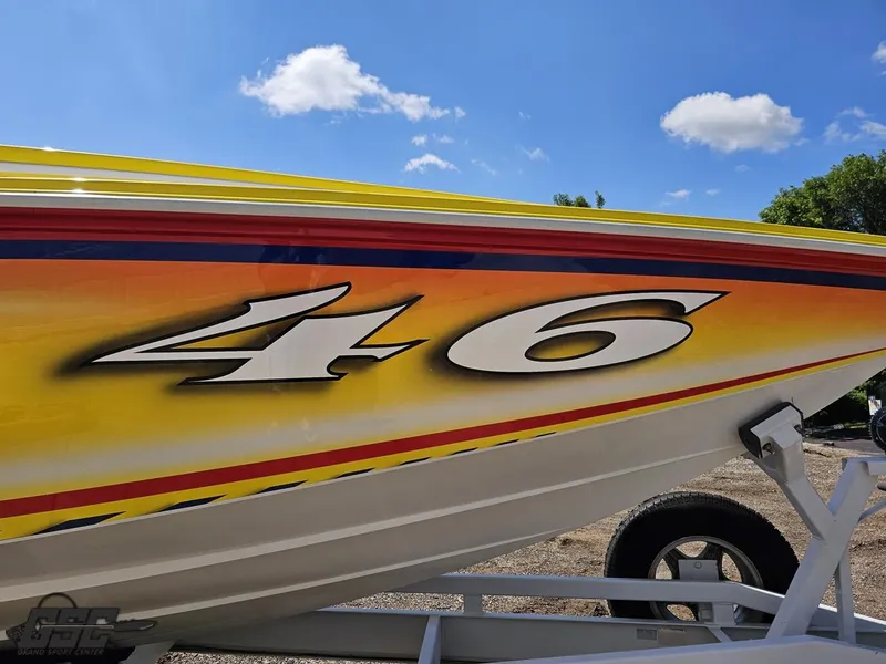 Slide: The Image of Colorful Sonic USA 45SS boat with bold "46" graphic, 2004 model, on trailer under blue sky. - 5