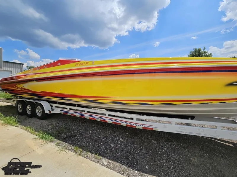Slide: The Image of Yellow and red 2004 Sonic USA 45SS speedboat on a trailer under a blue sky. - 6