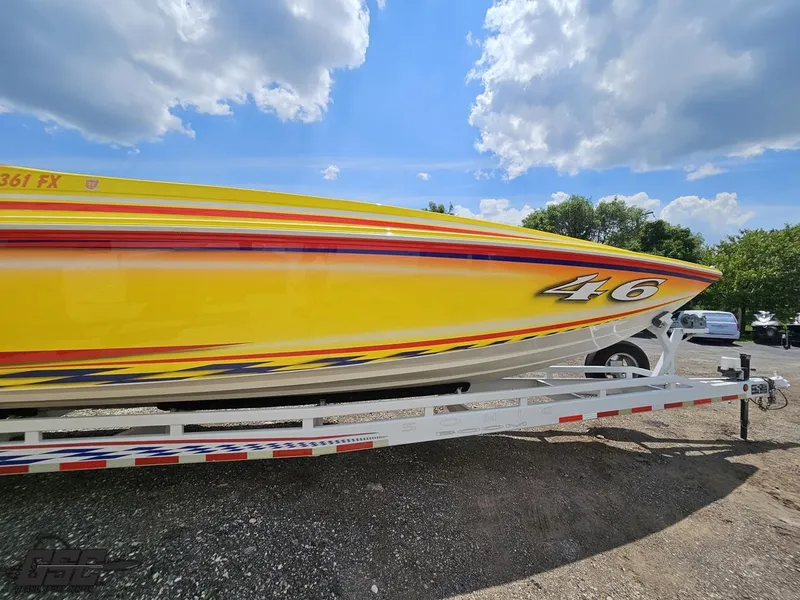 Slide: The Image of Yellow Sonic USA 45SS speedboat on trailer, vibrant design, under a partly cloudy sky. - 7