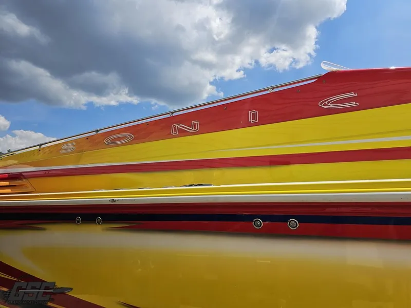 Slide: The Image of Colorful 2004 Sonic USA 45SS boat under a partly cloudy sky. - 9
