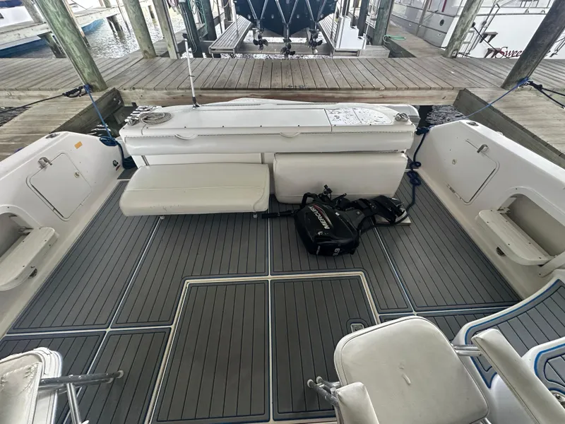 Slide: The Image of 1996 Sea Ray 440 Express Bridge boat interior with seating and equipment on deck. - 13