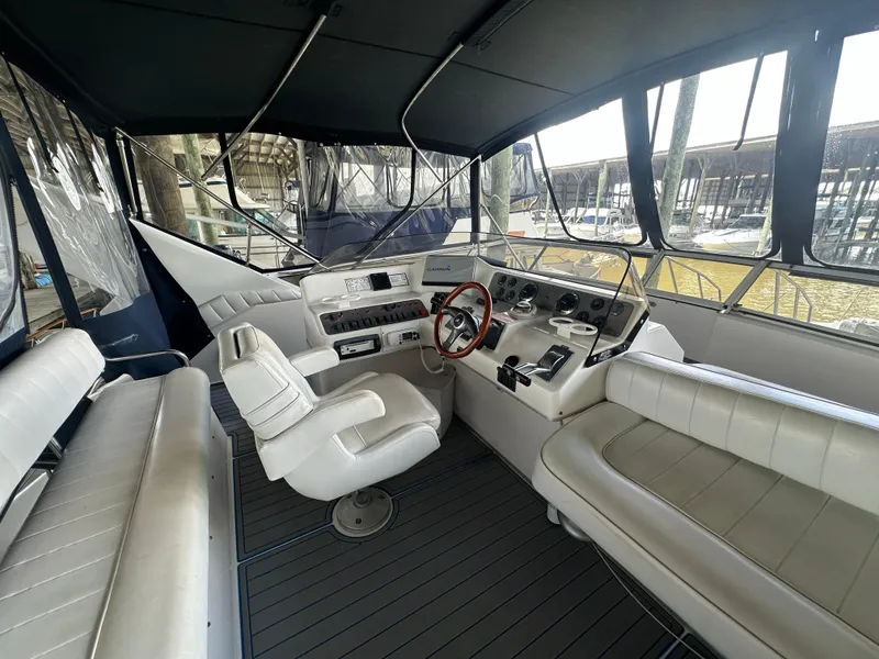 Slide: The Image of Interior of 1996 Sea Ray 440 Express Bridge yacht with helm and seating area. - 17