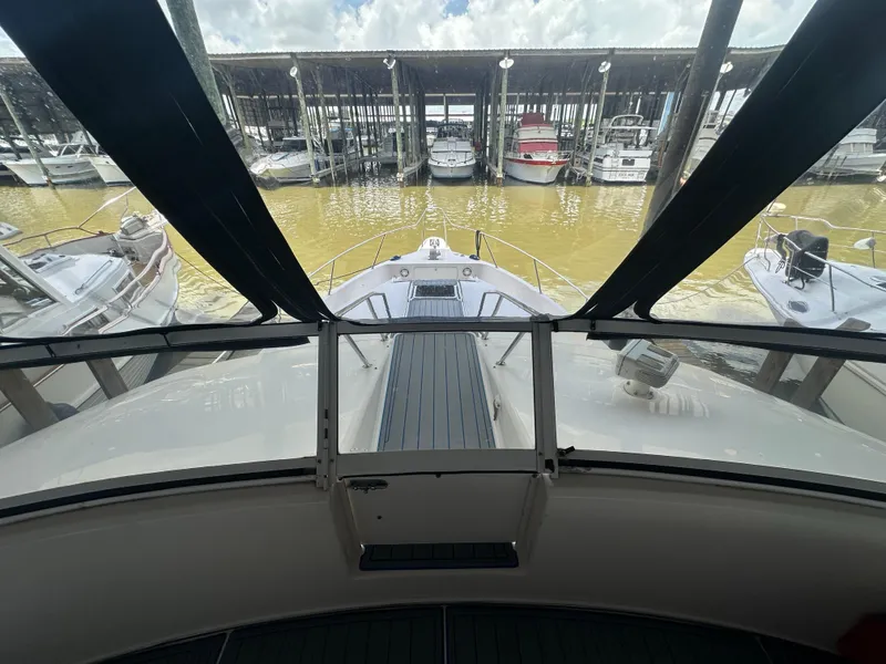Slide: The Image of 1996 Sea Ray 440 Express Bridge yacht docked at marina, viewed from helm. - 24