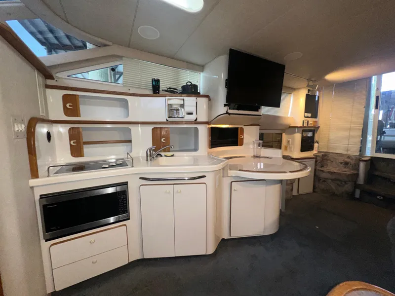 Slide: The Image of Interior of 1996 Sea Ray 440 Express Bridge yacht with modern kitchen amenities. - 33