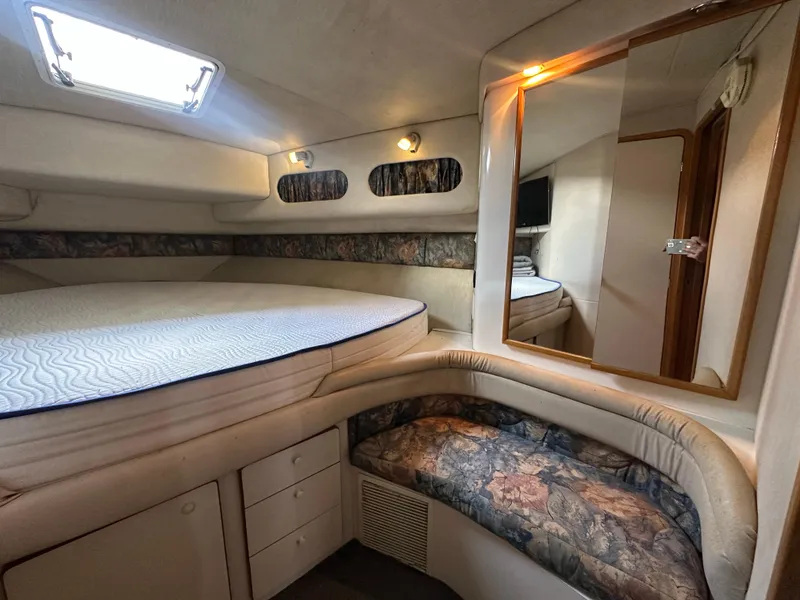 Slide: The Image of Interior cabin of 1996 Sea Ray 440 Express Bridge with bed, seating, and mirror. - 41