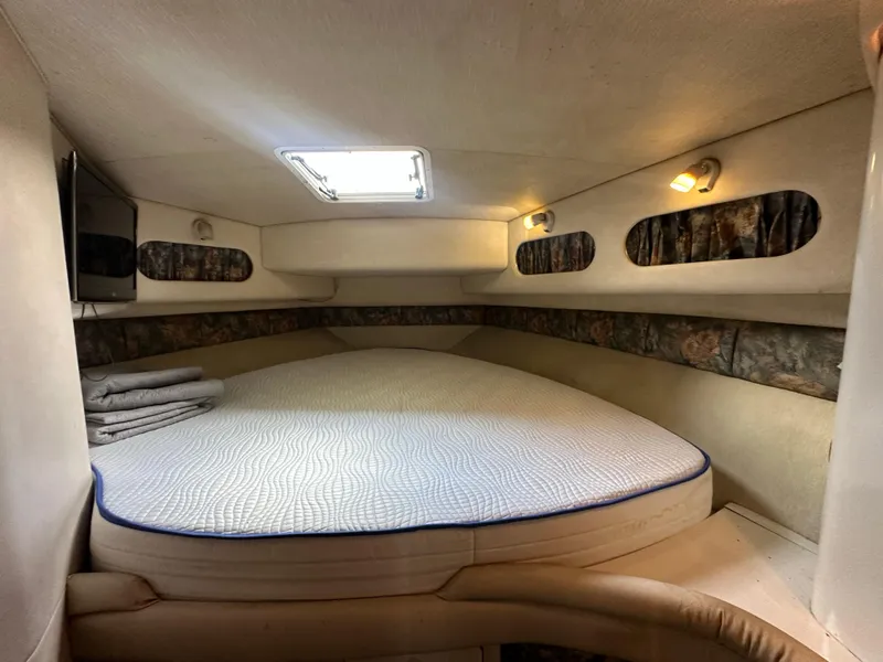 Slide: The Image of Cozy cabin interior of 1996 Sea Ray 440 Express Bridge with bed and lighting. - 43
