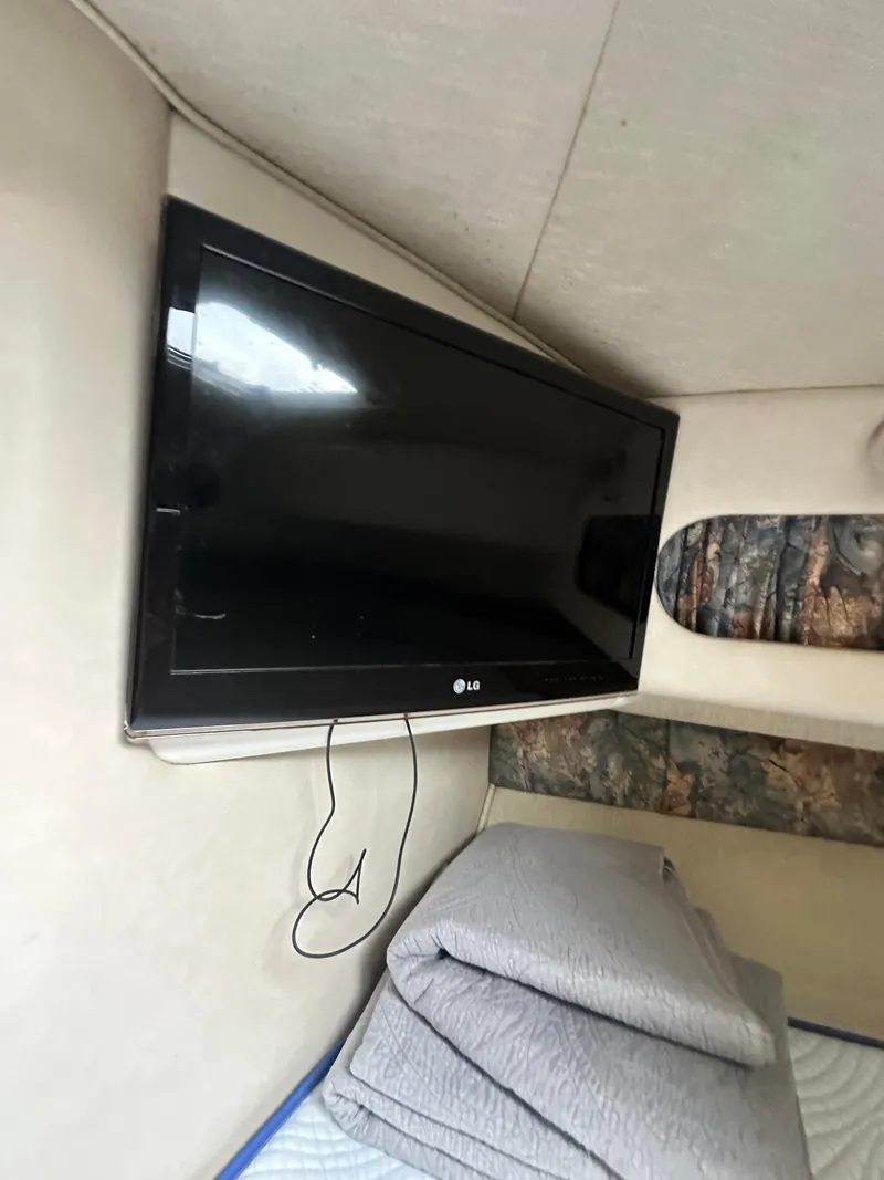 Slide: The Image of Interior of 1996 Sea Ray 440 Express Bridge with wall-mounted LG TV. - 46