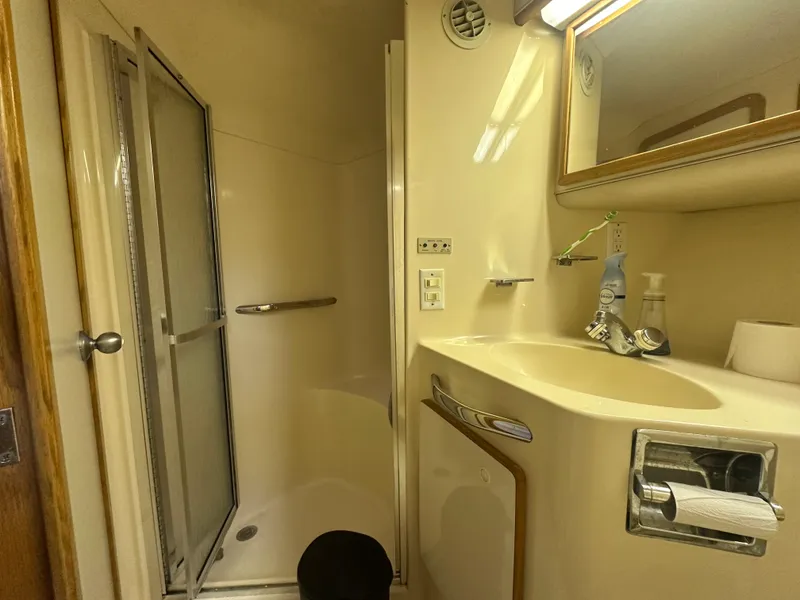 Slide: The Image of Bathroom interior of 1996 Sea Ray 440 Express Bridge yacht, featuring shower and sink. - 49