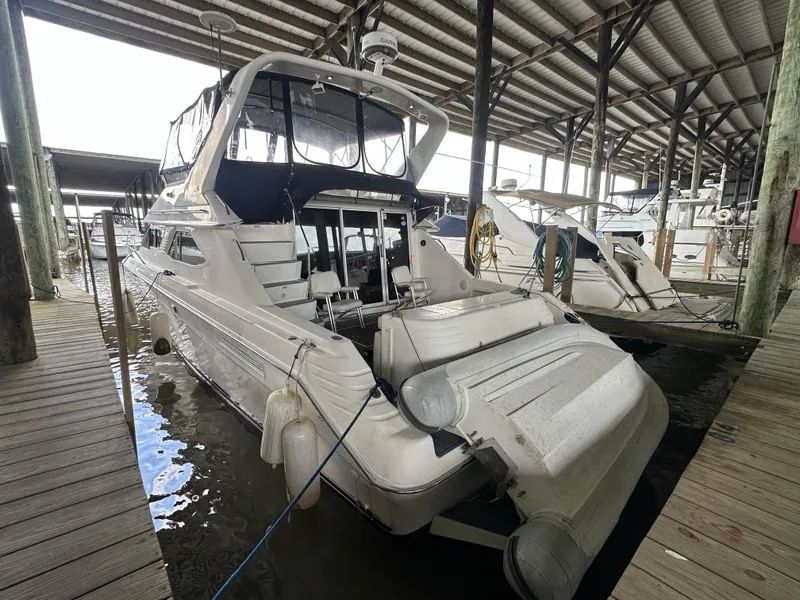 Slide: The Image of 1996 Sea Ray 440 Express Bridge docked under covered marina. - 5