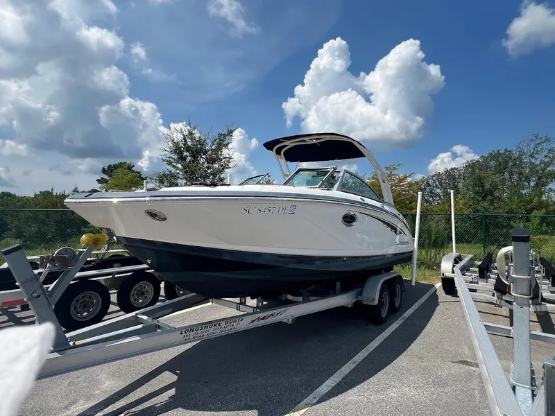 The Image of 2017 Chaparral 244 Sunesta boat on trailer under blue sky. - 0