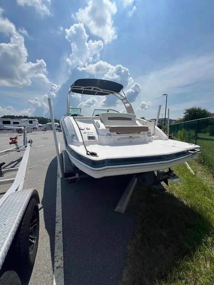 Slide: The Image of 2017 Chaparral 244 Sunesta boat on trailer under a sunny sky. - 11