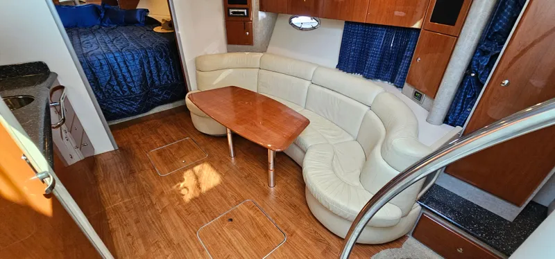 Slide: The Image of Interior of a 2007 Formula 37 Performance Cruiser with cream sofa and wooden table. - 32
