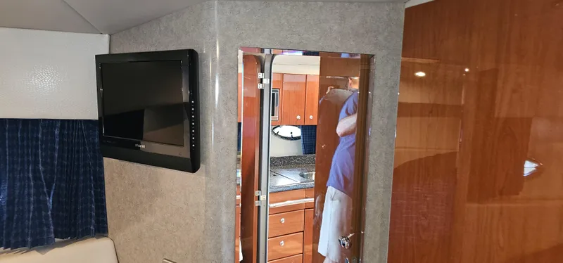 Slide: The Image of Interior of a 2007 Formula 37 Performance Cruiser with wood furnishings and a flat-screen TV. - 43