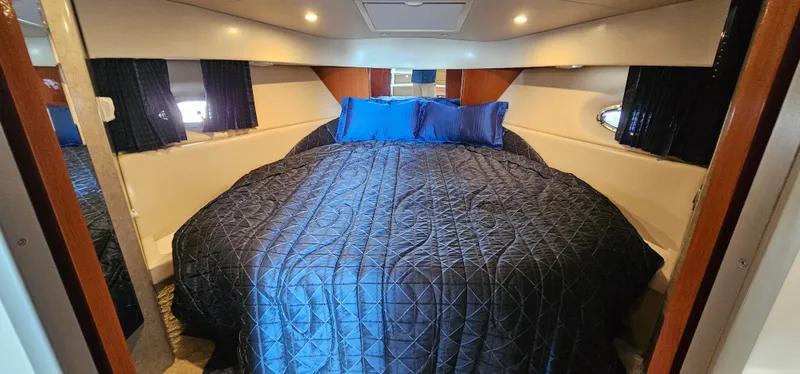 Slide: The Image of Cabin with a large, cozy bed, blue pillows, and elegant lighting. - 41
