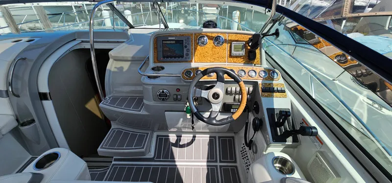 Slide: The Image of The cockpit of a 2007 Formula 37 Performance Cruiser with a modern dashboard and wood accents. - 19