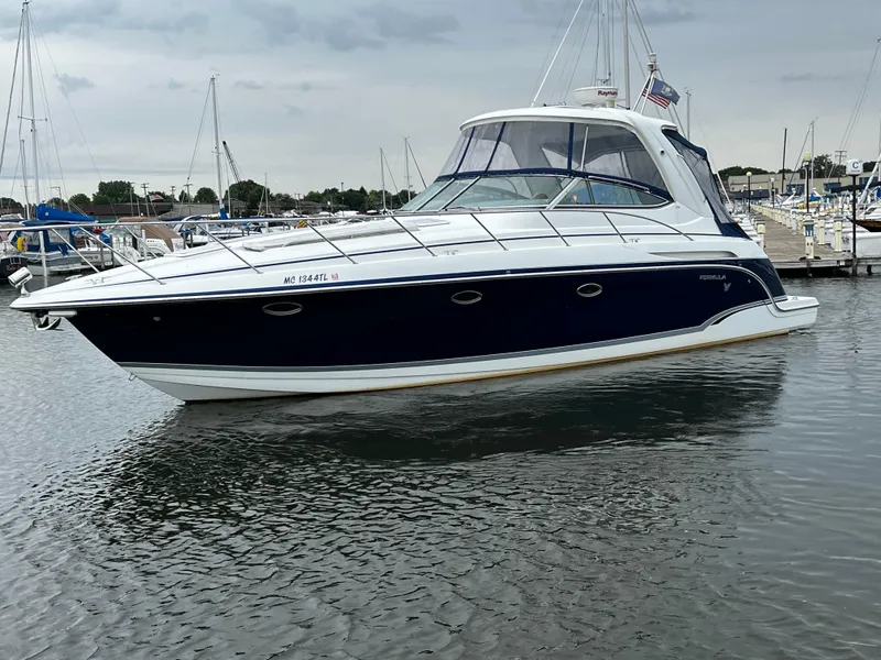 Slide: The Image of 2007 Formula 37 Performance Cruiser in harbor, sleek design with blue hull and white superstructure. - 2
