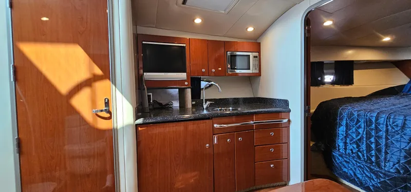 Slide: The Image of Interior of the 2007 Formula 37 Performance Cruiser featuring a kitchen and sleeping area. - 34