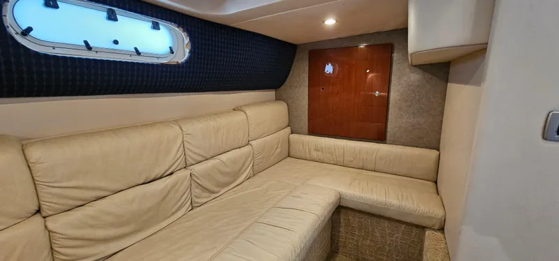 Slide: The Image of Interior of a 2007 Formula 37 Performance Cruiser with beige leather sofa and porthole. - 51