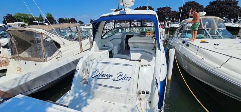 Slide: The Image of A white motor yacht docked in a marina, surrounded by other boats. A man cleans a nearby boat. - 7