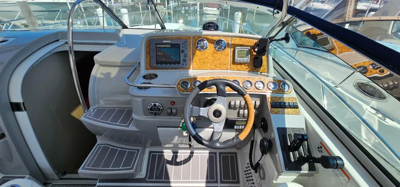Slide: The Image of The cockpit of a 2007 Formula 37 Performance Cruiser with modern instruments and a sleek steering wheel. - 24