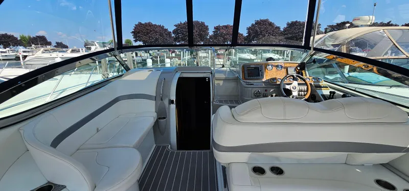 Slide: The Image of The cockpit of the 2007 Formula 37 Performance Cruiser features white upholstery and a modern dashboard. - 17