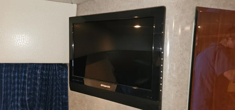 Slide: The Image of A flat-screen TV is mounted on the wall of a boat cabin. - 42