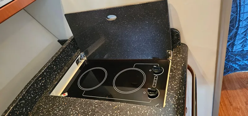 Slide: The Image of The galley of a 2007 Formula 37 Performance Cruiser featuring a modern cooktop. - 44