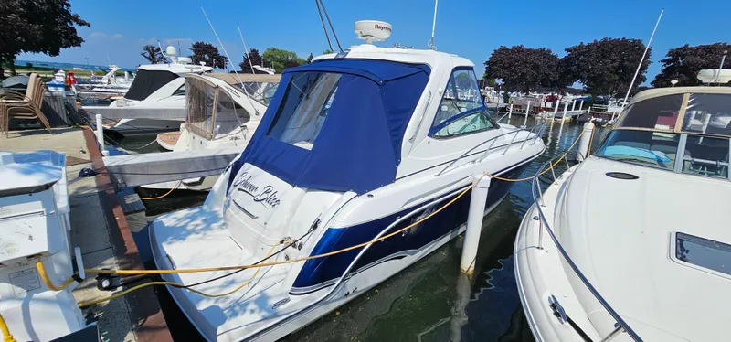 Slide: The Image of A 2007 Formula 37 Performance Cruiser docked at a marina, surrounded by other boats. - 3