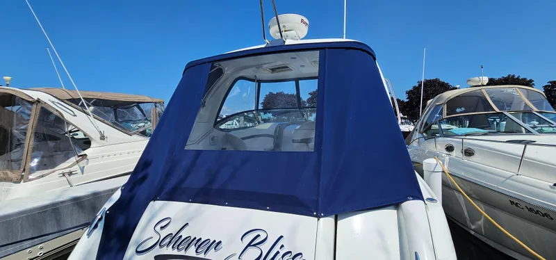 Slide: The Image of The rear of a 2007 Formula 37 Performance Cruiser with a blue cover at the marina. - 55