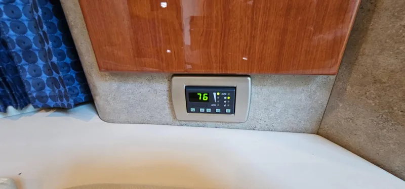 Slide: The Image of A temperature control panel displays 76 degrees, set in a wall with wood paneling. - 47