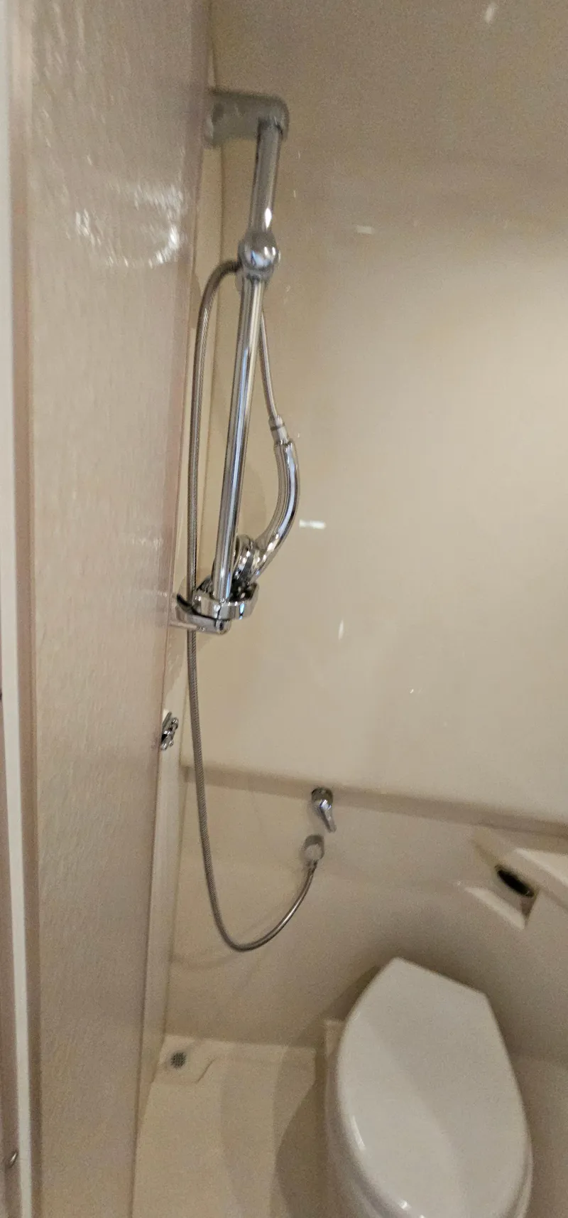 Slide: The Image of The yacht's wet room features a toilet and shower head. - 46