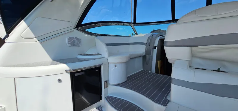 Slide: The Image of Interior of a 2007 Formula 37 Performance Cruiser with white and gray seating and a small fridge. - 15