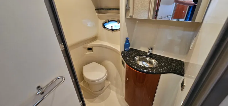 Slide: The Image of The image shows a boat bathroom with a toilet, sink, and porthole. - 45