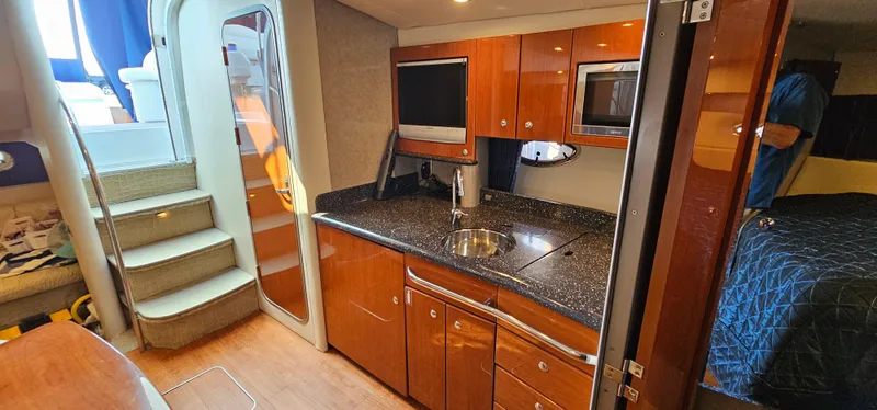 Slide: The Image of Interior of the 2007 Formula 37 Performance Cruiser with modern kitchen and stairs to cabin. - 38