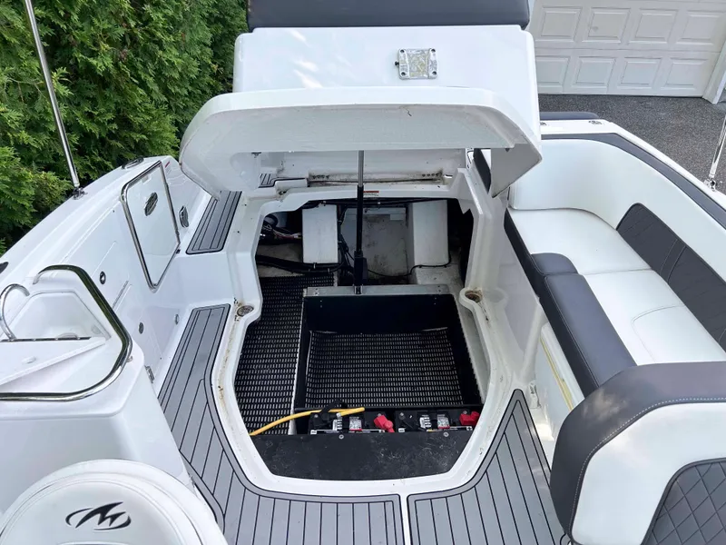 Slide: The Image of 2020 Monterey M-45 boat interior with open engine compartment, gray flooring, and white seating. - 16