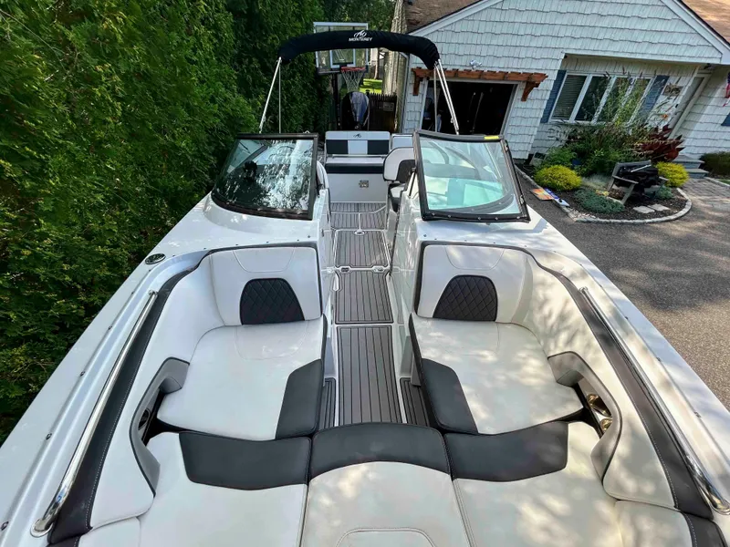 Slide: The Image of 2020 Monterey M-45 boat with spacious seating, docked near a house. - 8