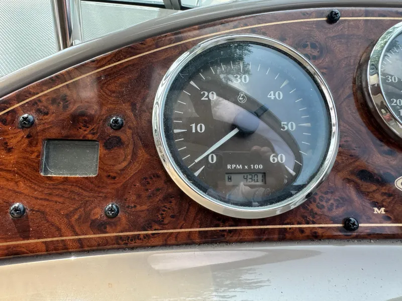 Slide: The Image of Dashboard of 2001 Maxum 3300 SCR boat showing RPM gauge at 430.1. - 14