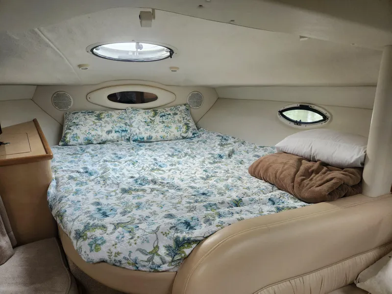Slide: The Image of Cozy cabin interior of 2001 Maxum 3300 SCR with floral bedding and porthole windows. - 24