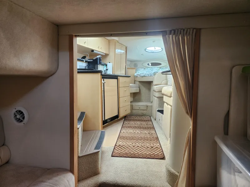 Slide: The Image of Interior of 2001 Maxum 3300 SCR yacht, featuring cozy cabin and kitchenette. - 26