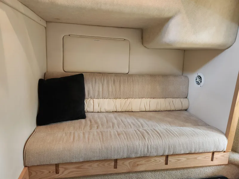 Slide: The Image of Interior of 2001 Maxum 3300 SCR boat with beige seating and black cushion. - 27