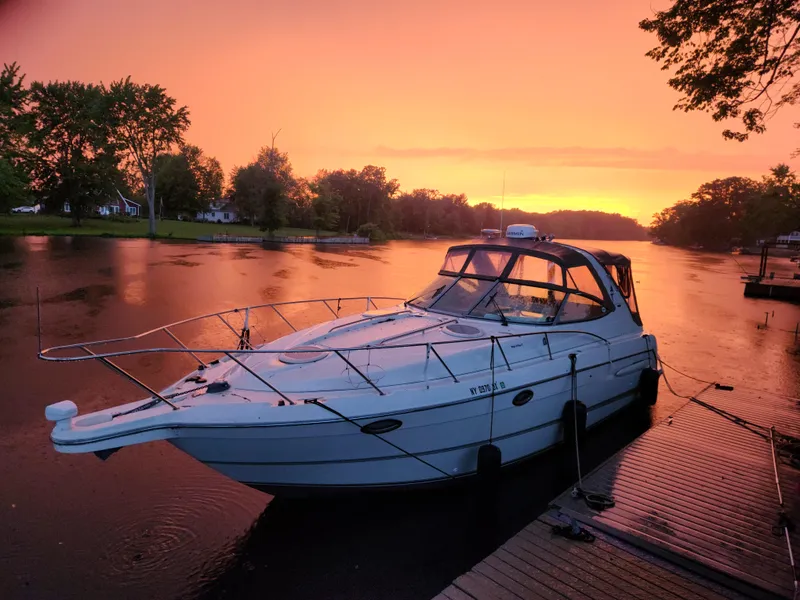 Slide: The Image of 2001 Maxum 3300 SCR boat docked at sunset on a serene lake. - 32