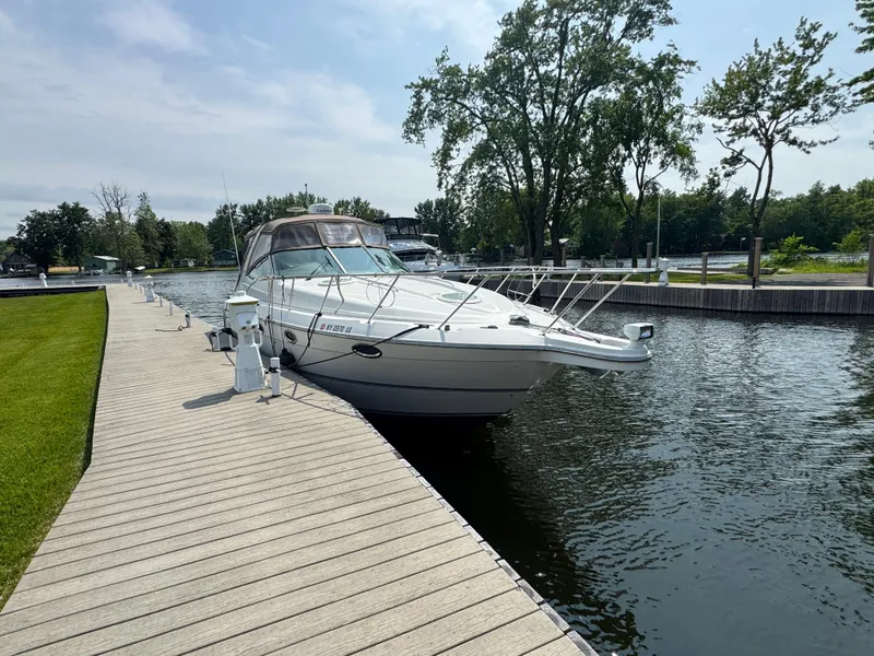 Slide: The Image of 2001 Maxum 3300 SCR boat docked on a sunny day by a wooden pier. - 4