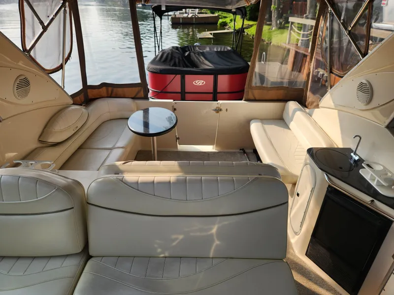 Slide: The Image of Interior of 2001 Maxum 3300 SCR boat with beige seating and compact kitchenette. - 8