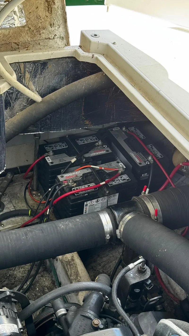 Slide: The Image of Engine compartment of a 1999 Trojan 40 Express with visible batteries and wiring. - 17