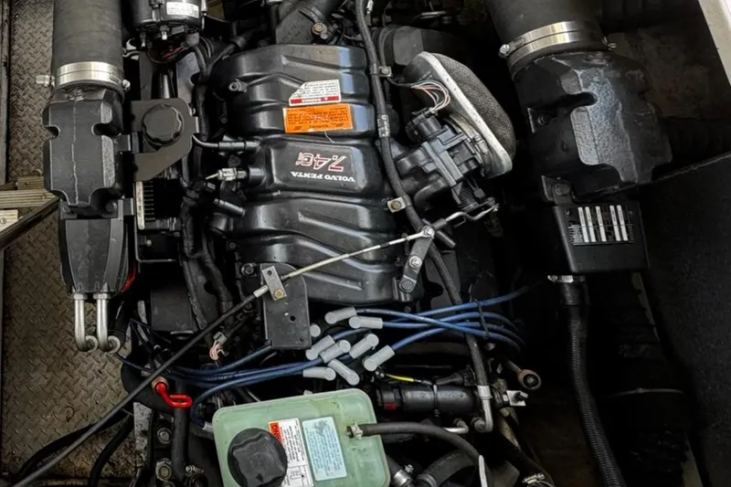 Slide: The Image of Engine compartment of a 1999 Trojan 40 Express boat, featuring a Volvo Penta engine. - 19