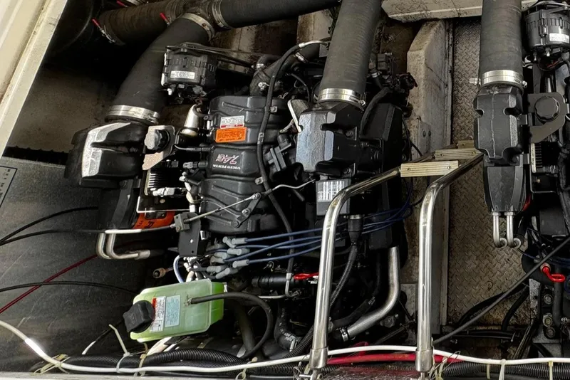 Slide: The Image of Engine compartment of a 1999 Trojan 40 Express boat, showcasing mechanical components and hoses. - 20