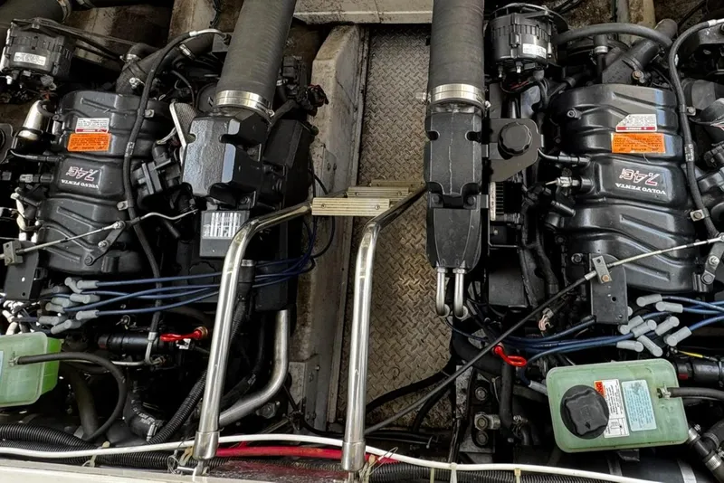 Slide: The Image of Engine compartment of a 1999 Trojan 40 Express boat, featuring dual Volvo Penta engines. - 21