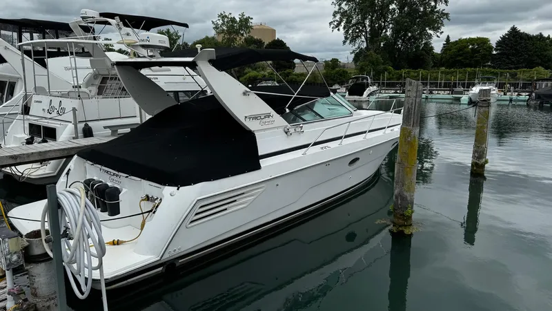 Slide: The Image of 1999 Trojan 40 Express yacht docked at marina, overcast sky. - 4